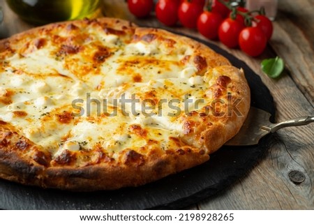 A slice of hot Italian pizza with stretching cheese. Pizza four cheeses with basil. Royalty-Free Stock Photo #2198928265