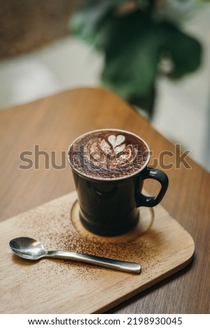 Hot Chocolate drink with latte art on wooden table