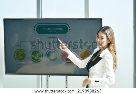 beauty Asian business womanman presenting work on television screen in office meeting room