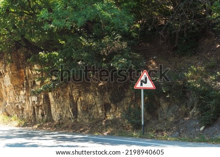 road sign dangerous road. white triangle with curved road sign