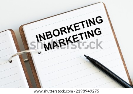 Inborketing Marketing text on an open blonde on a light background, business and marketing