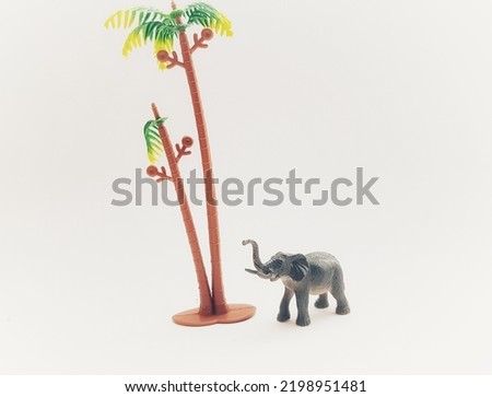 Children's toys made of solid plastic with the animal character of an elephant lifting its trunk