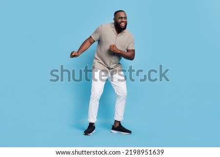 Full length photo of positive cheerful person enjoy clubbing dancing isolated on blue color background