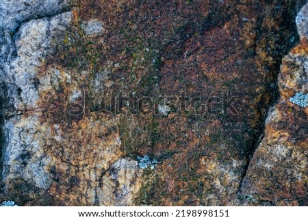 Raw gray granite rock texture background. Fragment of natural stone wall