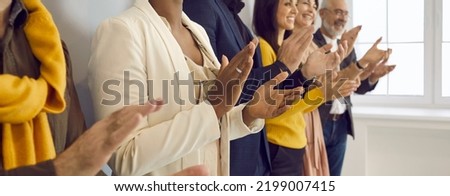 Happy business people clapping hands thanking coach for interesting lecture. Diverse male and female audience giving round of applause to express respect and gratitude to speaker. Banner background Royalty-Free Stock Photo #2199007415