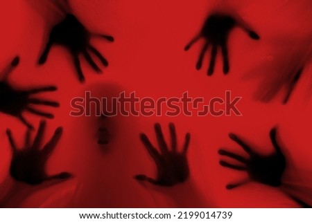 eerie blurry hands of people as if they have been trapped behind glass, dense fabric, wrap, ghost, spirit trying to reach out from afterlife, concept of violence, nightmares, halloween horror Royalty-Free Stock Photo #2199014739