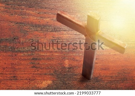 Wooden cross on the desk. Christian religion.