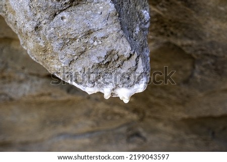 Detail of water falling on an ancient rock formation