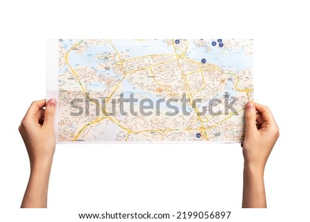 Hands holding map isolated on white background. Woman studying location for planning journey, orientation in area. Tourism, travel, sightseeing concept. High quality photo