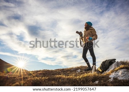 Mid Adult Woman Photographer Enjoying Morning in Wilderness at First Rays of Sun