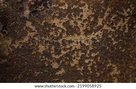 Rusty metal background. Corrosion of metal on the wall surface. Photo of antique armor from a cannon.