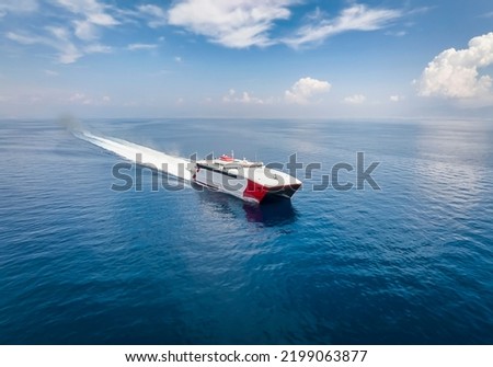 Aerial view of a catamaran jet passenger ferry traveling with speed over blue ocean Royalty-Free Stock Photo #2199063877