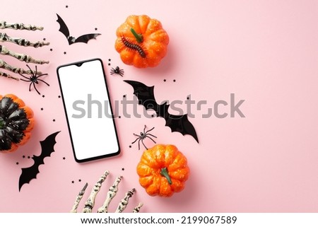 Halloween concept. Top view photo of pumpkins smartphone bat silhouettes skeleton hands spiders centipede and confetti on isolated pastel pink background with copyspace
