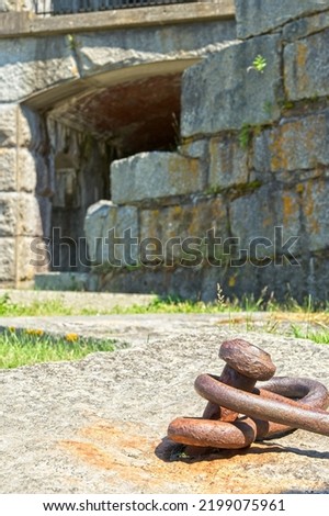 Iron anchor point in granite footing with granite stone casemate walls in background at Fort Popham, a military base constructed from 1862-1869 to protect the mouth of the Kennebec River, Maine. 