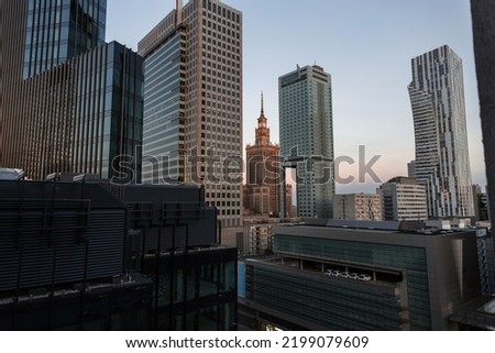 Amazing modern European city of Warsaw, Poland with its tall office buildings and the historic Palace of Culture. Urban backdrop with buildings. Downtown at evening Royalty-Free Stock Photo #2199079609