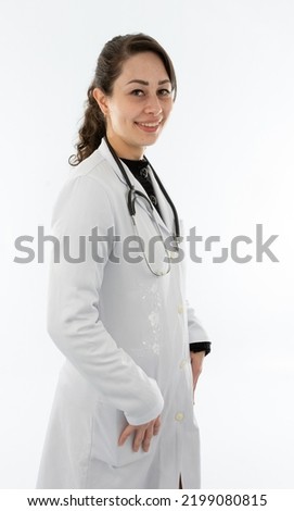 Young doctor medicates Brazilian woman with white coat and light skin, photo studio with model Royalty-Free Stock Photo #2199080815