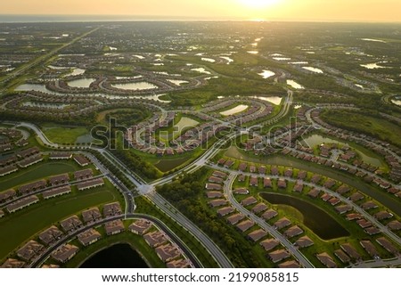 View from above of densely built residential houses in closed living clubs in south Florida. American dream homes as example of real estate development in US suburbs Royalty-Free Stock Photo #2199085815