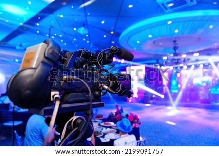 broadcast video camera with rechargeable battery to show what is happening on stage on large screens. professional equipment for the banquet.