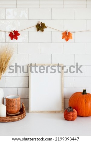 Living room interior design with autumn fall decor and picture frame mockup. Thanksgiving, Halloween holiday poster concept.