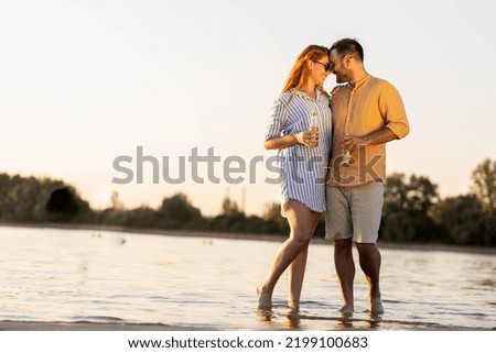 Couple holding hands, laughing, walking in the river barefoot .
Summer time stock photo
Couple in love