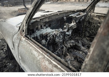 Interior of Burnt car because of Forest Fire - Bushfire Crisis and Global Collapse Royalty-Free Stock Photo #2199101817