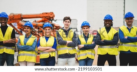 Multiracial engineers working inside robotic factory - Focus on center guy face