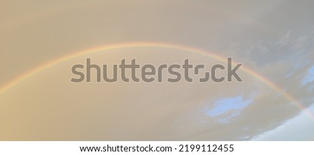 Double rainbow on the cloudy sky