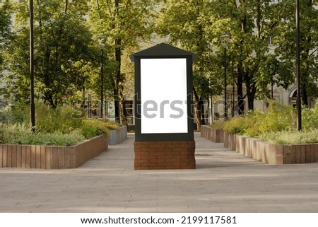 Blank billboard in park. White advertising banner or display template on city street for marketing and promotion. Editable mocap on background of alley or cityscape. Design element for websites