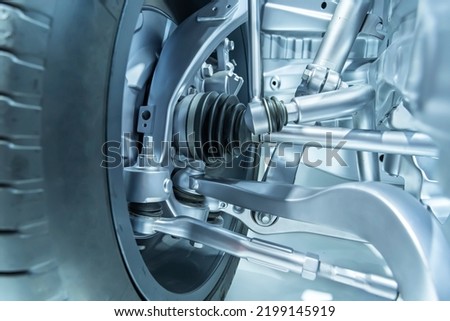 electric system of eco car front driving axle in the car, visible elements of the steering system Royalty-Free Stock Photo #2199145919