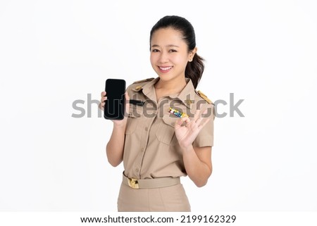 Portrait of Asian woman showing or presenting mobile phone application and ok sign isolated over green background, Asian Thai model
