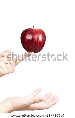studio photography of hands holding a beautiful red apple