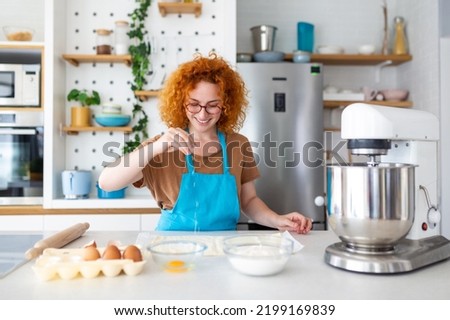 Baking Concept. Portrait Of Joyful Woman Kneading Dough In Kitchen Interior, Cheerful Female In Apron Having Fun While Preparing Homemade Pastry,