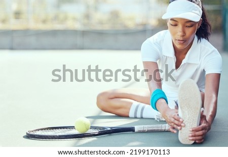 Tennis player, exercise and competitive sport with a woman stretching to prepare for a game or match on an outdoor court. Fitness with a female player sitting and doing warmup workout and practice Royalty-Free Stock Photo #2199170113
