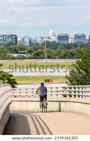 Biker on Bridge with view of the United States Capitol Building and Washington, DC skyline in the distance - Arlington, Virginia, USA (Washington, DC Metropolitan Area)
