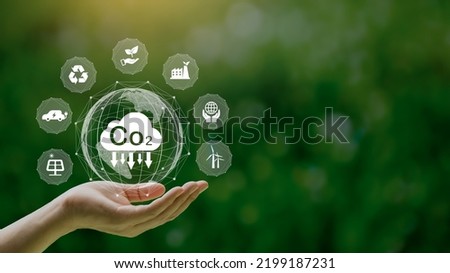 Reduce CO2 emission concept in the hand with icons, global warming for environmental.Net zero and carbon neutral concept. Royalty-Free Stock Photo #2199187231