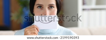 Woman is holding piece of paper with smile. Positive mood and emotions concept