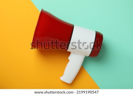 Red and white megaphone on two tone background Royalty-Free Stock Photo #2199190547