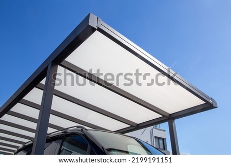 Modern and high quality carport on a residential house Royalty-Free Stock Photo #2199191151