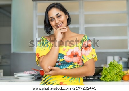 Beautiful hispanic mother or housewife at kitchen indoors at home Royalty-Free Stock Photo #2199202441