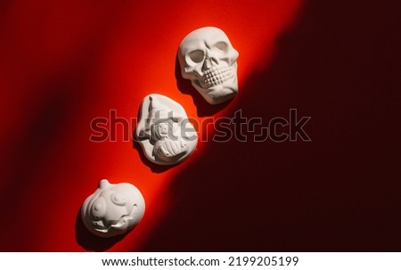 plaster figure of a pumpkin, skull on a color background. Halloween concept