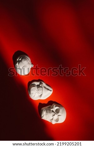 plaster figure of a pumpkin, skull on a color background. Halloween concept