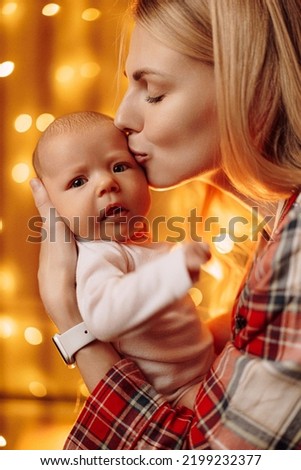 mother with a baby in her arms. mother with a newborn child, motherhood and its difficulties.Parent, child. Happy family. Fun family. Smiling happy child. Child care.