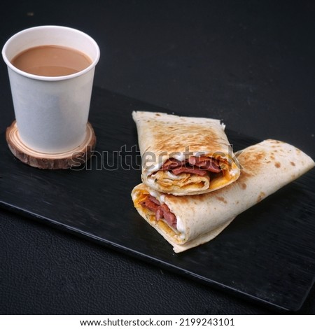 Tea Cup Full Of Tea on a A piece of wood Royalty Free Stock Photo, Picture, beside have a tasty shawarma