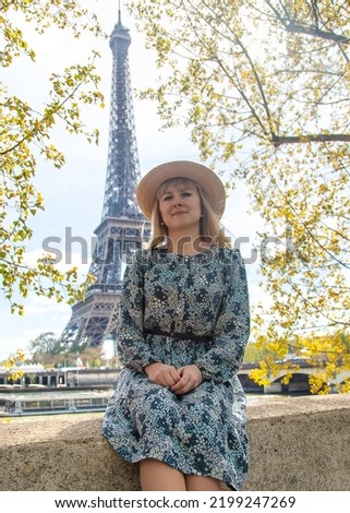 Woman in a hat near the eiffel tower. Selective focus. People.