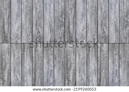 Laminate background. Texture of natural wood. The flooring is made of gray boards and panels. Parquet laid lengthwise, end to end