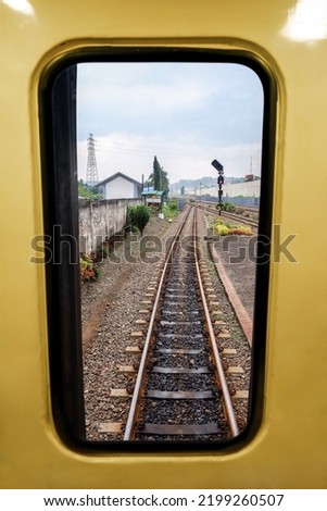 framing in the window, the railroad with its environment surroundings