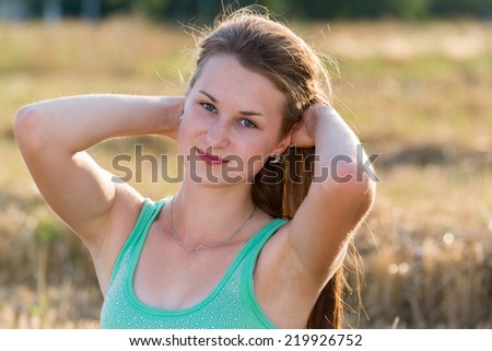a Teen girl resting in a field