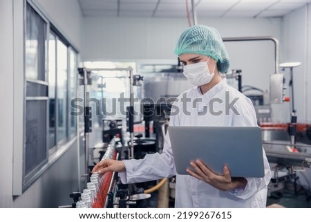 food and drink industry staff worker working at conveyor belt production line machine in beverage factory with clean and hygiene area. Royalty-Free Stock Photo #2199267615