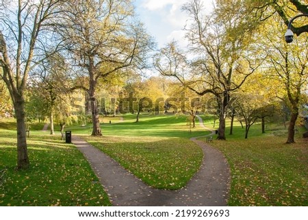View of the Winckley Square gardens public park with the forking walking path in autumn in Preston, Lancashire, England, UK