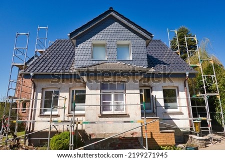 Old single-family house with scaffolding is being renovated
 Royalty-Free Stock Photo #2199271945